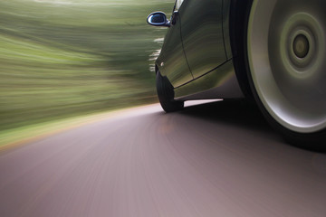 side view of black sport car in blurred motion