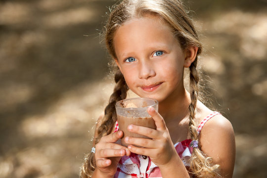 Cute Girl Drinking Milk Chocolate.