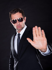 Portrait Of Young Man Making Stop Gesture
