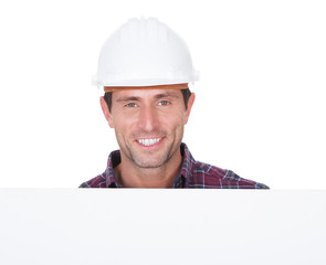 Man Wearing Hard Hat Holding Placard