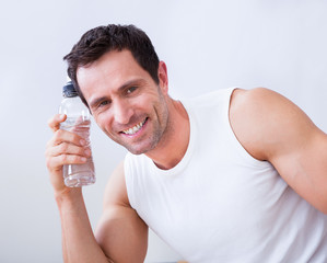 Young Man Holding A Bottle Of Water