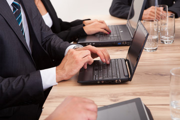 Businesspeople Using Laptop