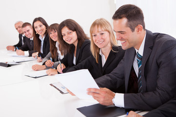 Businessman Showing Paper To His Colleagues