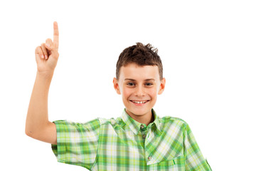 Naklejka premium Schoolboy pointing up, isolated on white