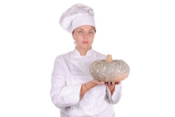 young female chef showing a pumpkin, isolated on white