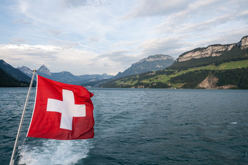 Swiss flag flutter above the lake