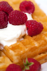 waffles with wheaped cream and raspberrries