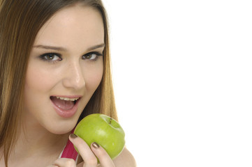 Beautiful young girl holding a green apple