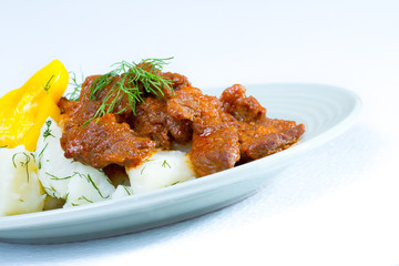 Beef stroganoff over boiled potatoes with pepper and dill