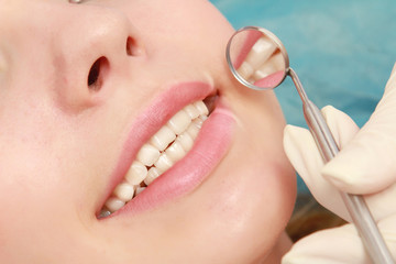 Examining patient's teeth, closeup