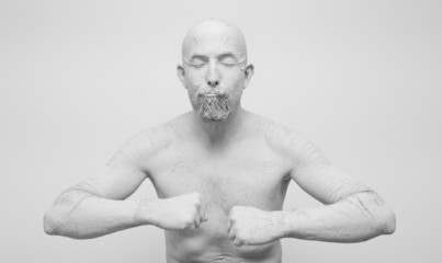 Human in white clay, golem, alive statue