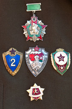 Badges of Russian frontier guards on a green uniform.