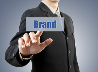 businessman hand pushing brand button