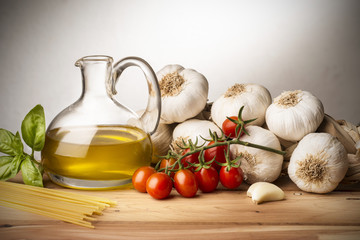 still life with olive oil,vegetables on wood table