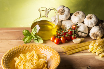 stil life with olive oil,vegetables on wood table