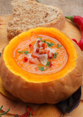 Homemade pumpkin soup on rustic background