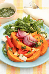 Pumpkin salad with arugula, parmesan and pesto