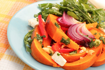 Pumpkin salad with arugula, parmesan and pesto
