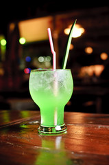 Green cocktail on wooden table