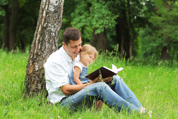 father and daughter reads the Bible