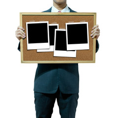 Business man holding cork board on the background