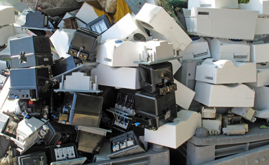 Obsolete counters of electricity thrown in waste landfill - obrazy, fototapety, plakaty