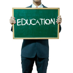 Business man holding blackboard on the background , Education