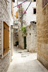 View on narrow alley - Trogir, Croatia.