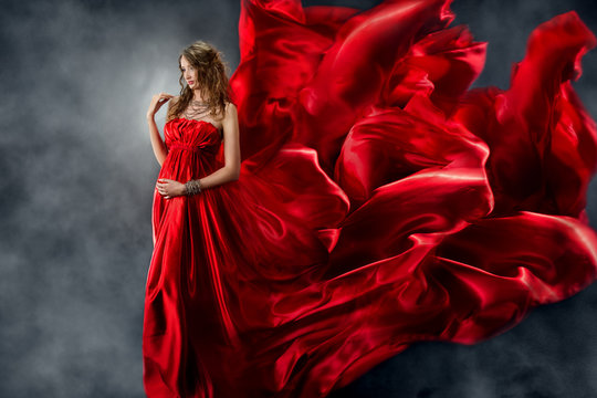 Beautiful woman in red waving flame silk dress
