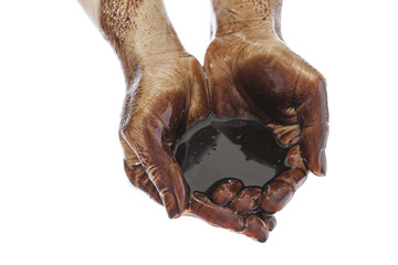 Hands cupped with black heavy fuel isolated on white background