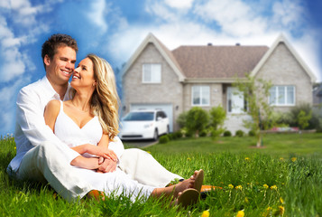 Happy family near new house.