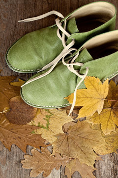 green leather boots and yellow leaves