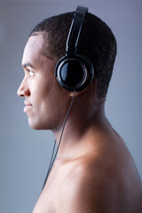 Young black man listening to music in headphones