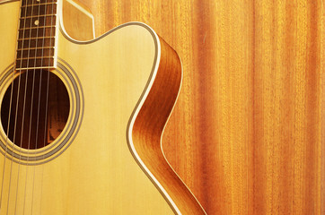 Acoustic guitar on wood background