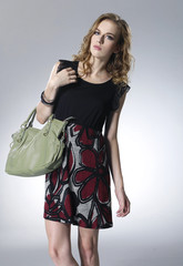 beautiful fashionable woman with handbag