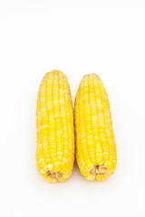 Two corn on white paper