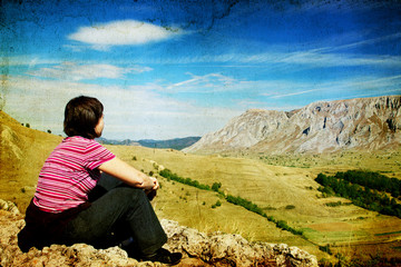 Woman resting on cliff's edge