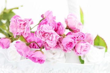 Beautiful pink roses in wedding basket