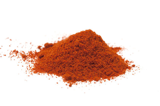 Pile of red paprika powder  on white