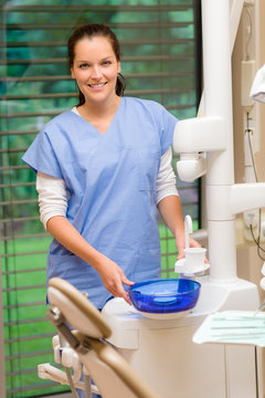 Female dentist assistant at dental surgery smiling
