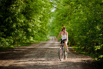 Naklejka premium Biker on the forest road
