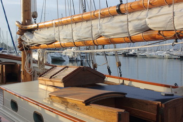 classic wood sailing yacht with mast sail deck and varnished hatch
