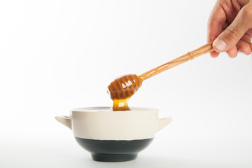 juicy honey in a cup and spoon