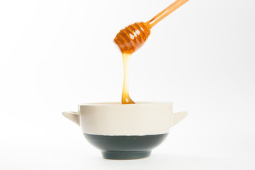 juicy honey in a cup and spoon