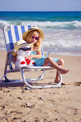 девочка сидит на шезлонге на берегу моря