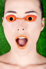 Closeup of a beautiful woman wearing tanning bed glasses with mo