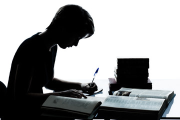 one young teenager boy or girl silhouette studying reading books