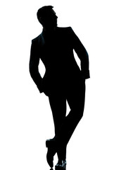 one business man standing Full length hands in pocket silhouette