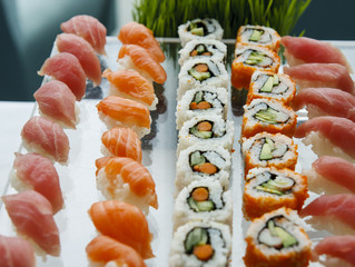 Sushi and California Rolls on Glass Tray