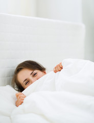 Female hiding behind blanket